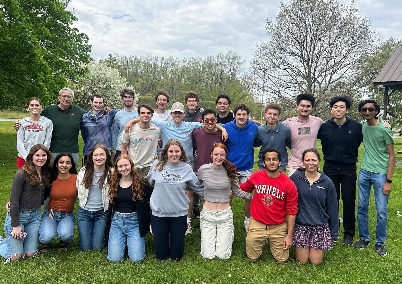 Group of people posing in a field